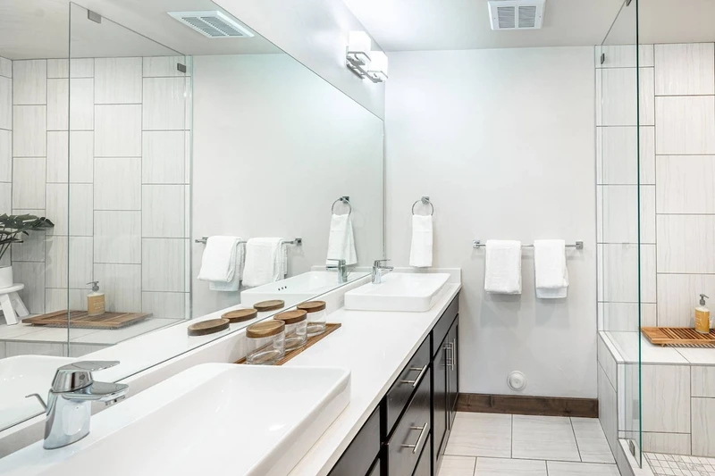 Double sinks are featured in the primary suite's bathroom and an oversized walk in shower