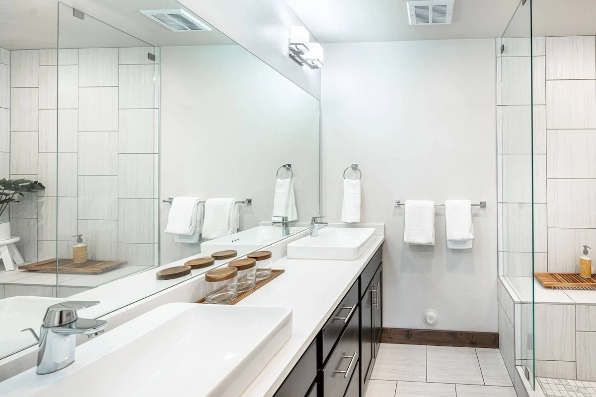 Double sinks are featured in the primary suite's bathroom and an oversized walk in shower