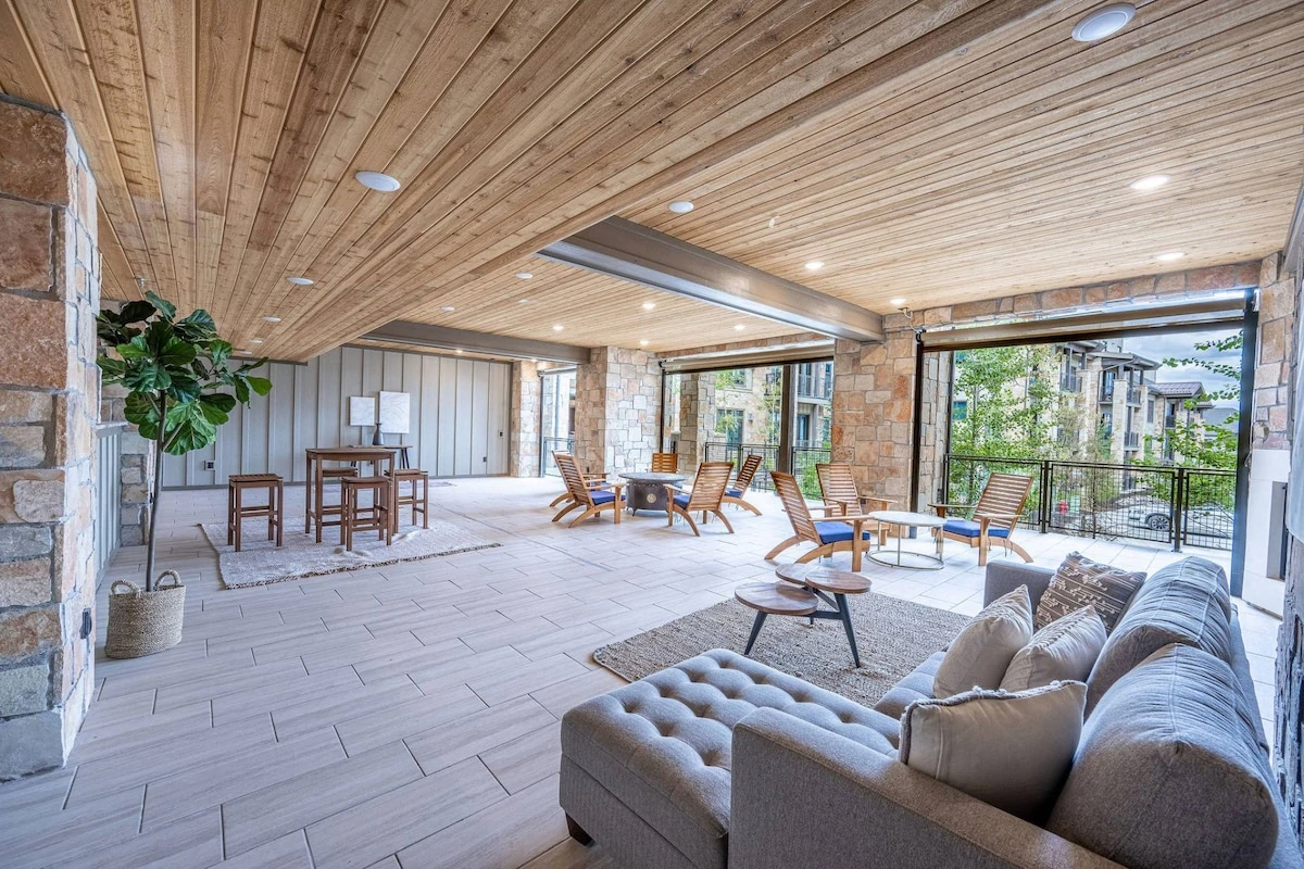 Communal space with outdoor patio furniture and large fire pit