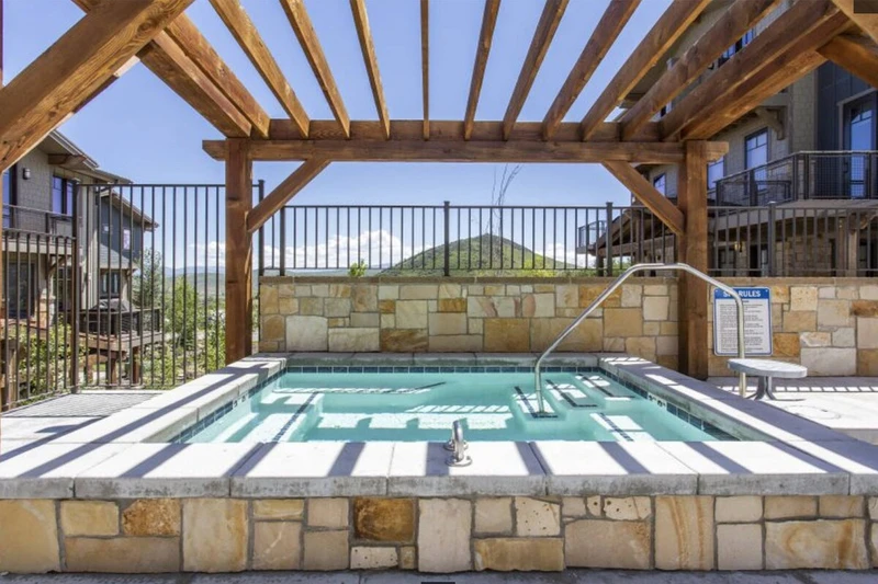 The communal hot tub is located at the clubhouse which is just steps from the home and is open year around