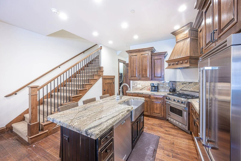 This high end home has a stainless steel farmhouse sink and the bedrooms up both upstairs to provide endless privacy