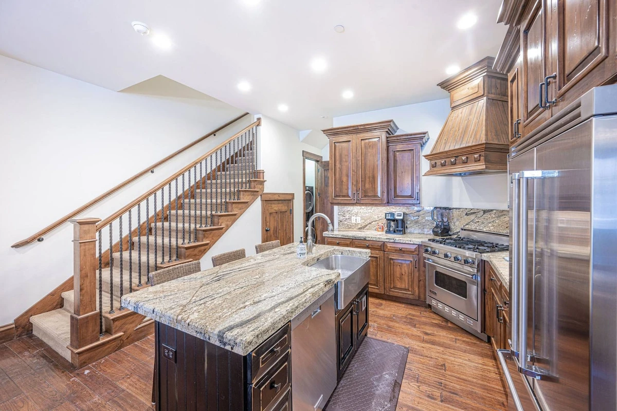 This high end home has a stainless steel farmhouse sink and the bedrooms up both upstairs to provide endless privacy