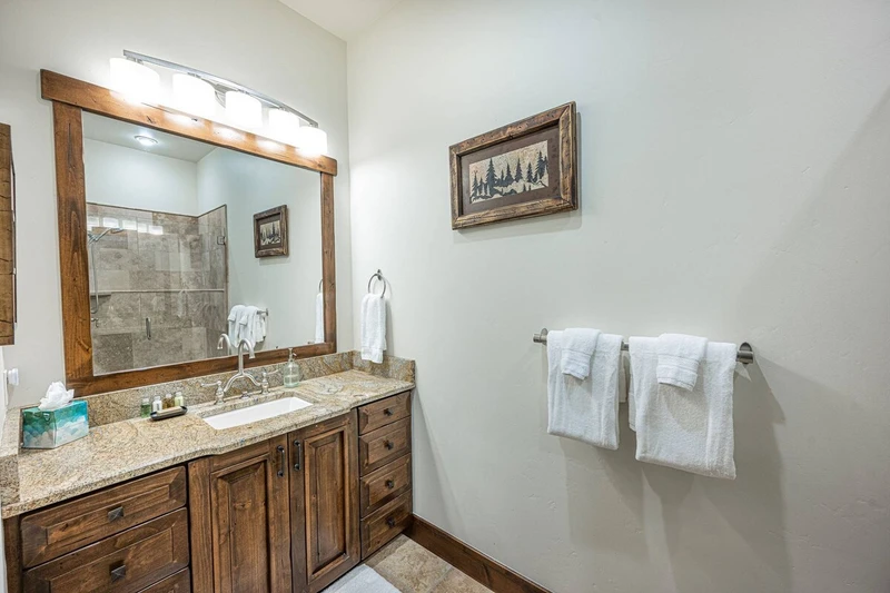 The primary bedroom's en suite bathroom boasts a luxury granite vanity with plenty of storage.