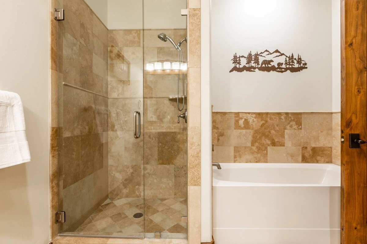 The en-suite bathroom is equipped with a large soaking tub and an immaculate glass shower.
