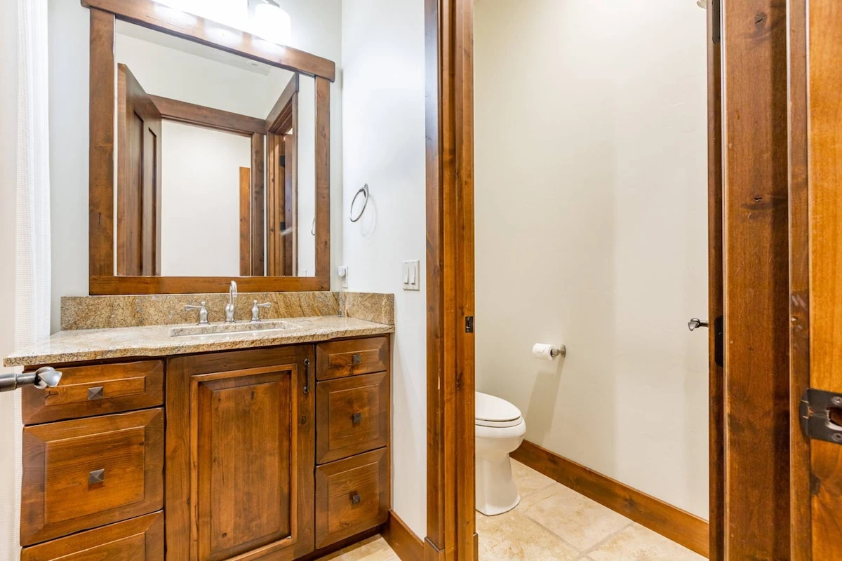 The en-suite bathroom is equipped with a dual-vanity sink.