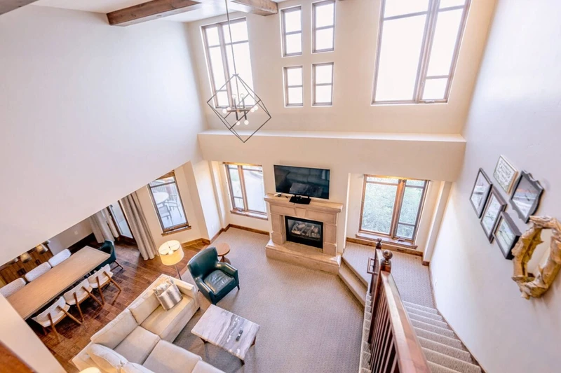 Living room with comfortable seating and TV, open to the kitchen and dining area.