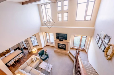 Living room with comfortable seating and TV, open to the kitchen and dining area.