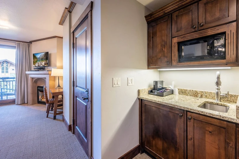 Coffee Bar in the primary suite has a microwave, sink and coffee maker.