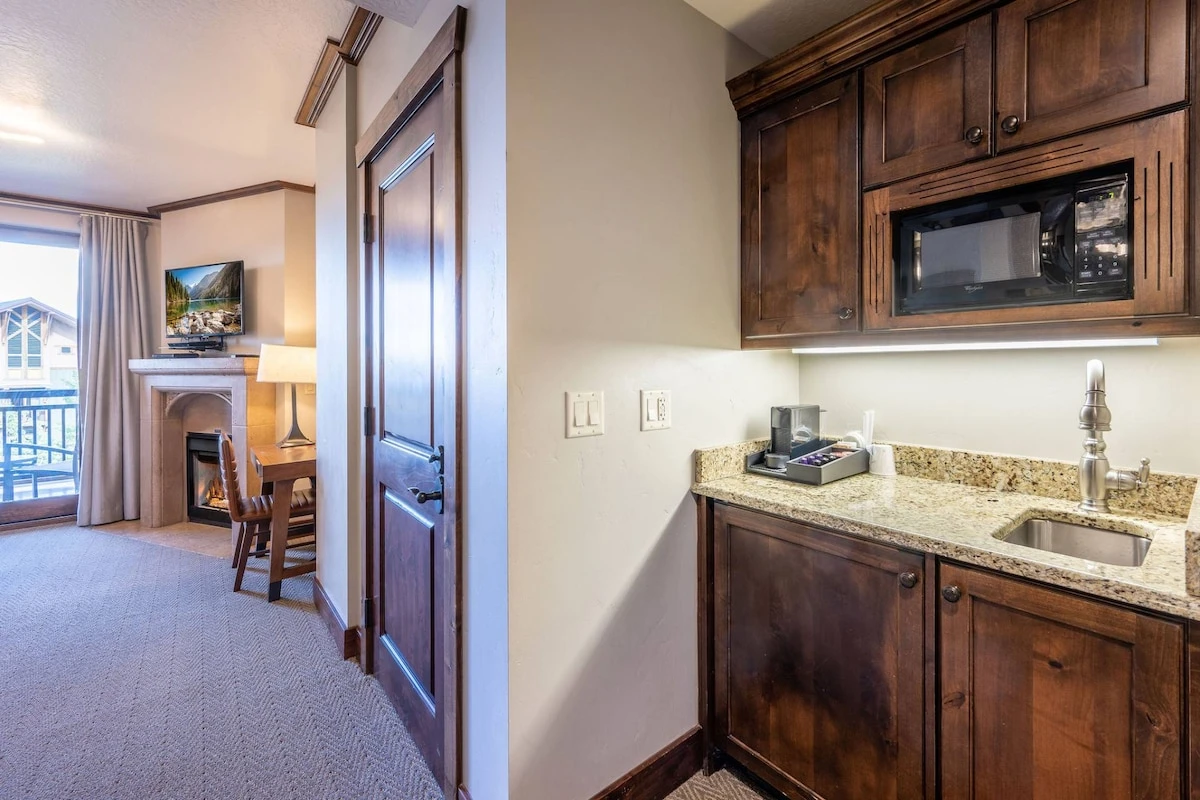 Coffee Bar in the primary suite has a microwave, sink and coffee maker.