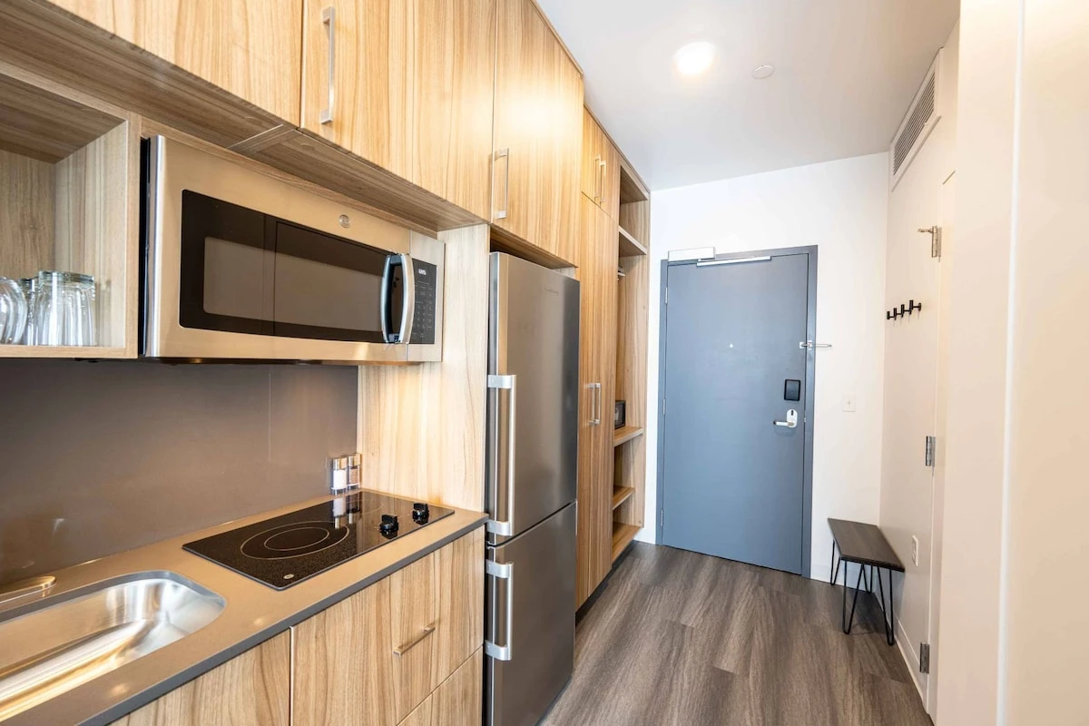 Full Gourmet Kitchenette with a full sized fridge, freezer, 2 burner stove, dishwasher, and microwave