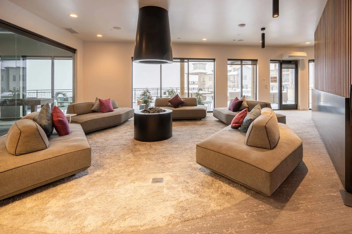 Connect with friends and family while lounging on this modern couch and enjoying the open air fireplace