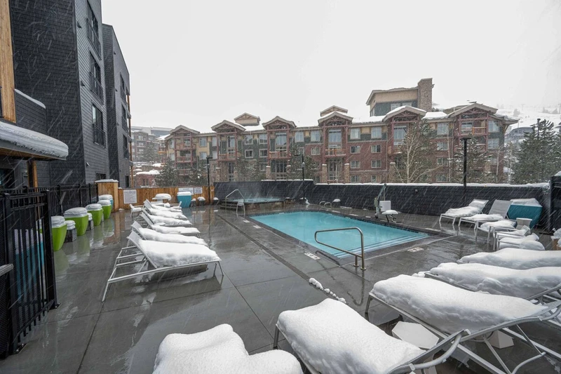 The year around heated pool & hot tub are located just out the back door of the building and just steps away from the home