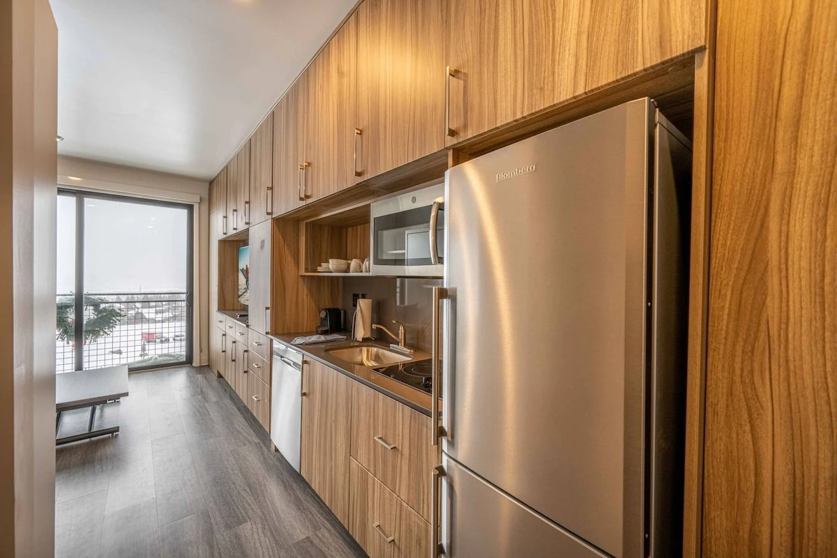 Full Kitchenette with a dishwasher, 2 burner stove, microwave, fridge, and freezer. The kitchen comes stocked with plates, silverware, and basic cookw