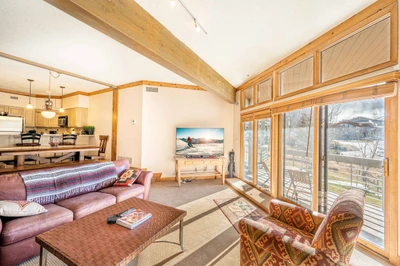 Cozy family room with great natural lighting and mountain views and access to deck