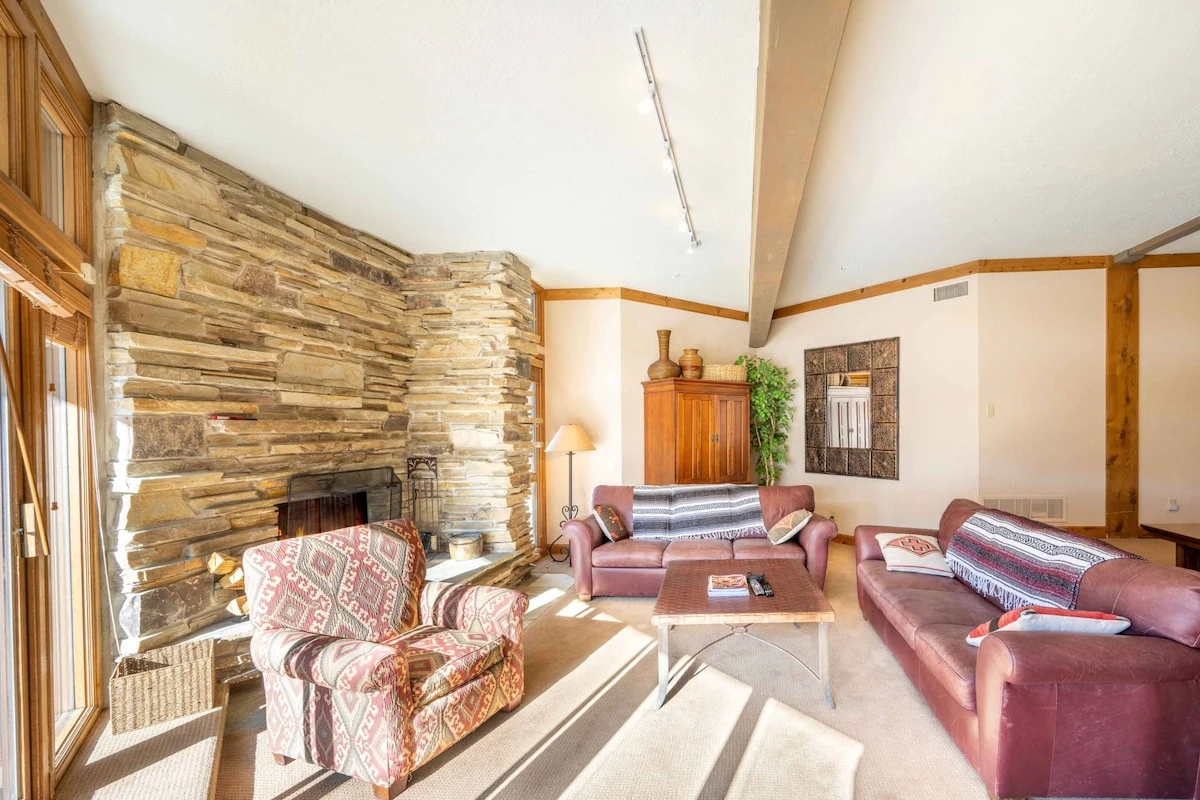 After a long day skiing, guests can walk back and cozy up in the family room with plenty of couches to cuddle up on, with access to the spacious deck.