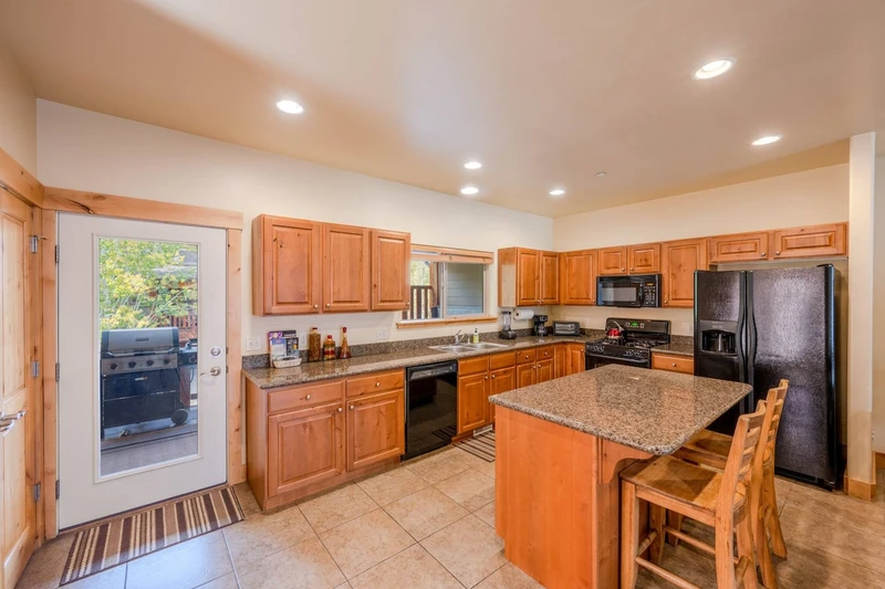 A refrigerator, stovetop, oven, microwave and dishwasher are at hand in the lovely kitchen with granite counter tops and convenient butcher-block isla
