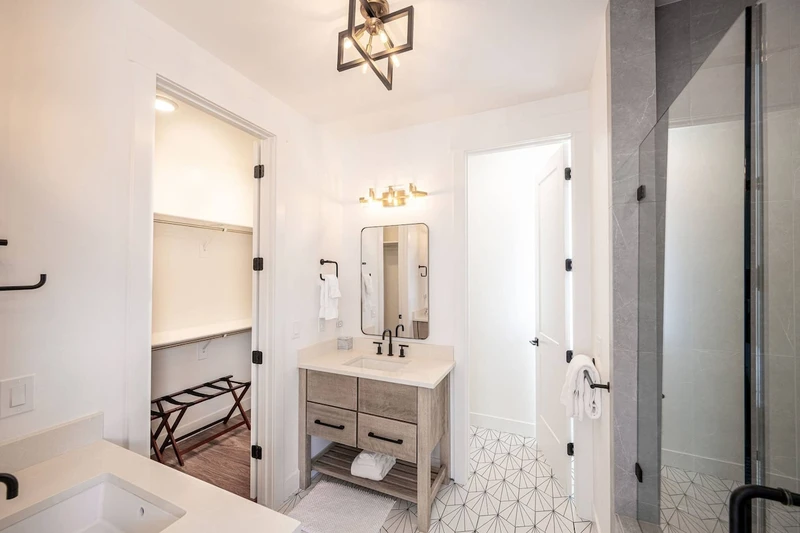 Through the sliding barn door is the exquisite en suite bathroom
