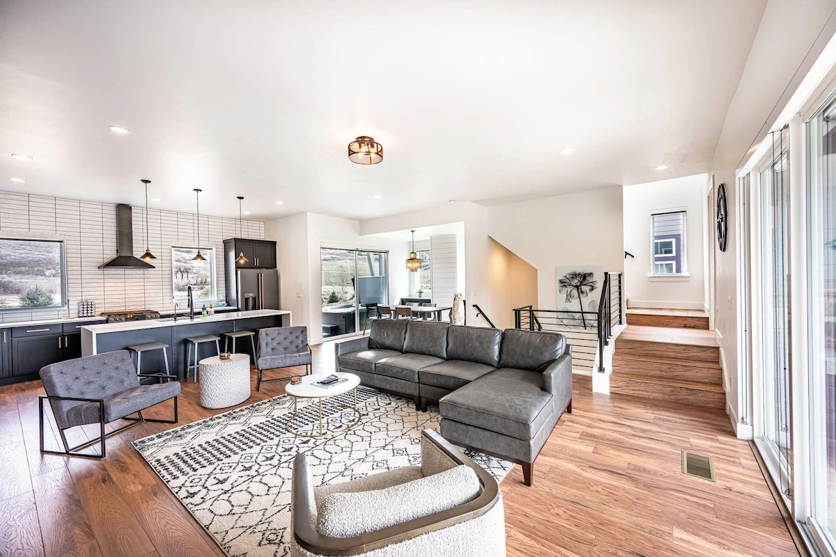 The welcoming open concept floor plan is filled with a refined combination of matte black, chic white and warm woods to create a chic interior