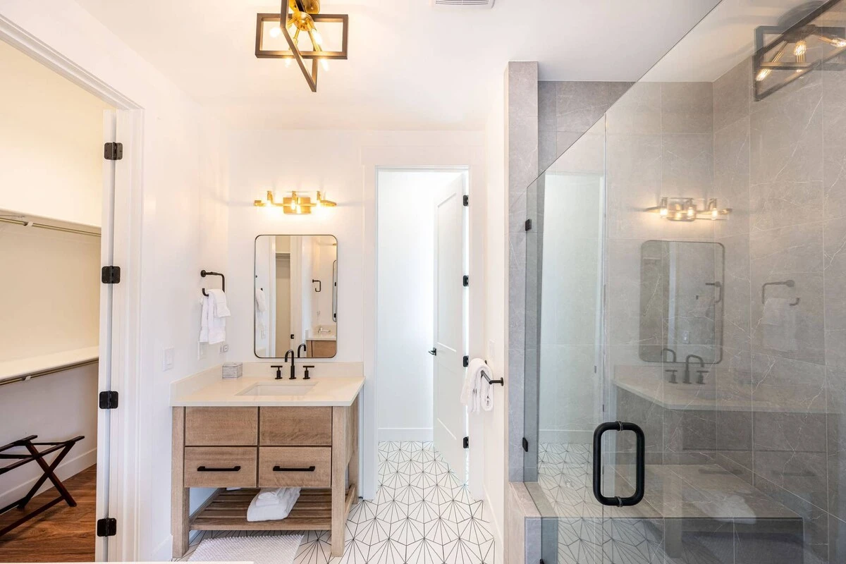 With an oversized walk-in glass shower, custom tiles and two vanities the room feels like a private spa.