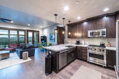 Fully Stocked Kitchen with Full Size High End Stainless Steel Appliances, Breakfast Bar and Open Floor Plan