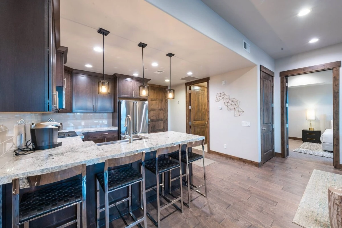 The bright and spacious kitchen has a lovely breakfast bar with barstool seating for up to four guests, the granite countertops provide ample space fo