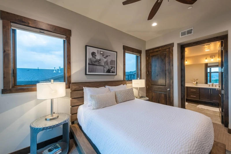 The spacious primary suite has a spa-like bathroom connected to the bedroom area.