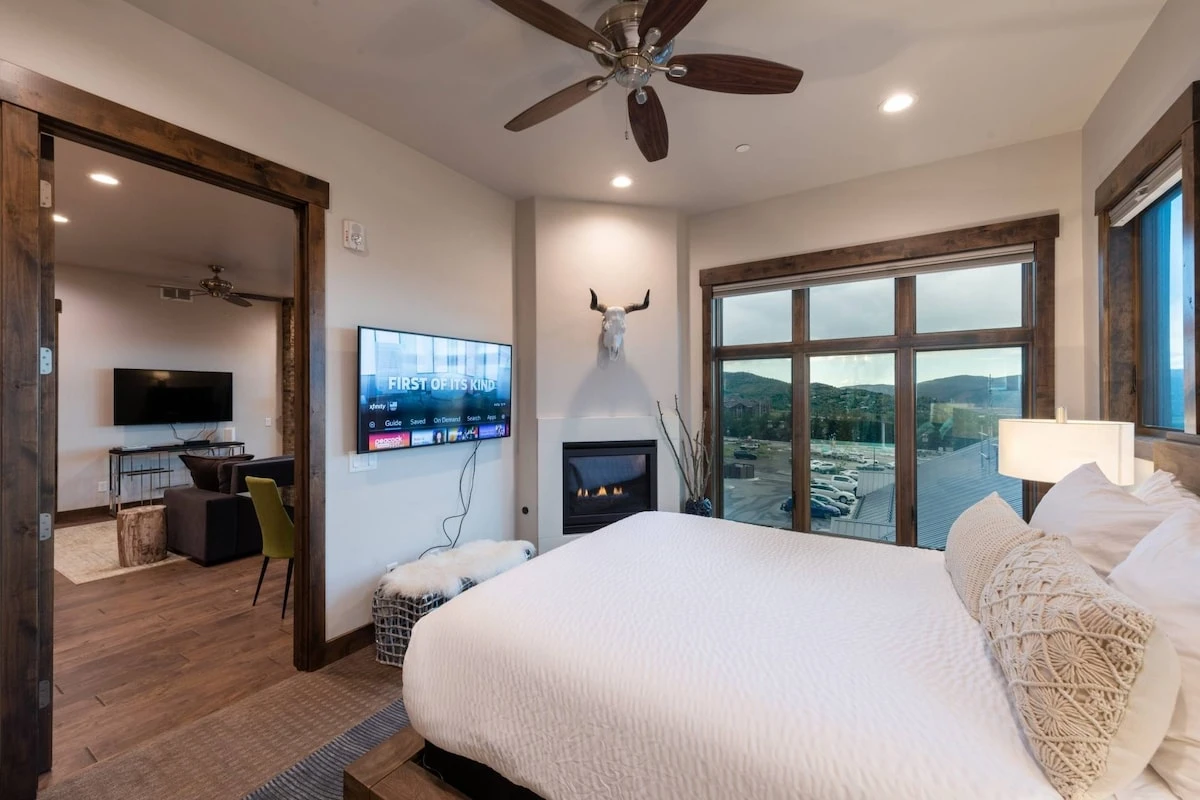 The primary suite is a private oasis with a private fireplace, large windows, custom hardwood bed, plush king mattress outfitted with high quality lin