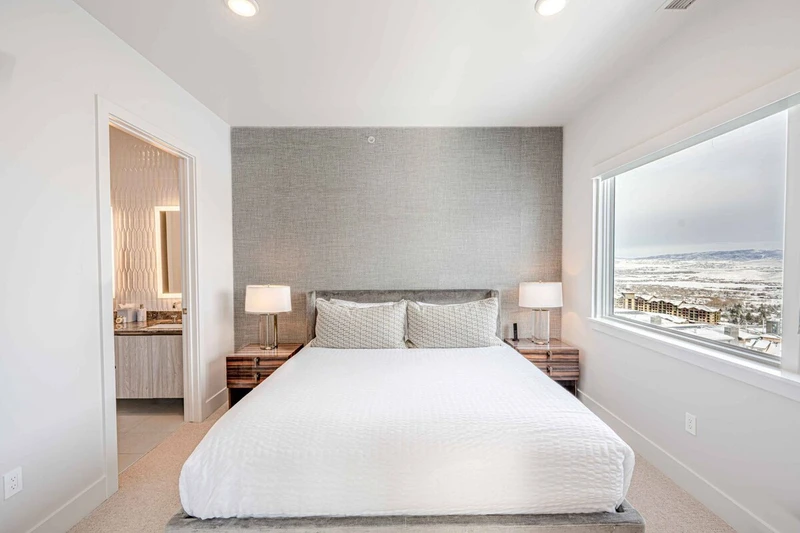 Guest suite with large windows, mountain and valley views, natural light, and ensuite bathroom—no compromise on comfort for additional guests.