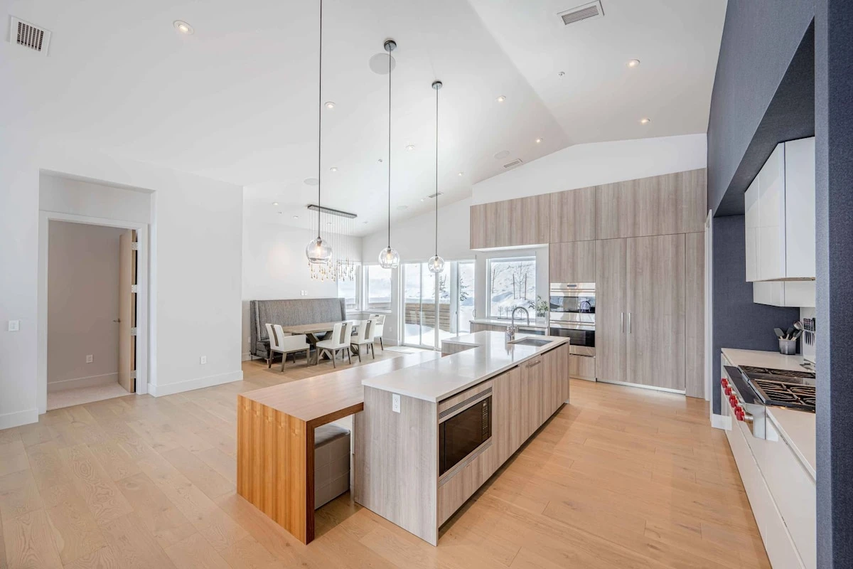 The spacious gourmet chef's kitchen features white marble countertops with lots of space for preparing meals. The high end appliances any chef would a