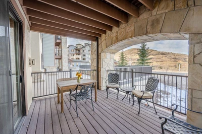 Featuring comfortable seating, dining table and side tables the private covered patio is a perfect place to take in the panoramic views
