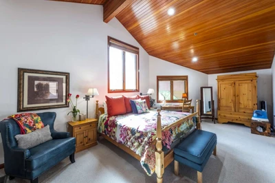 Master Suite Offers A Private Top Floor Oasis - Bright & Cheery Bedroom with King Bed, Office Area, Sitting Area, HDTV and En Suite Bathroom Complete