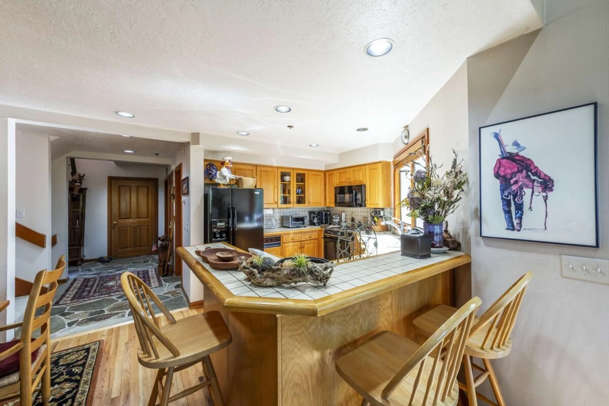 The breakfast bar provides the perfect place to gather in the kitchen. In addition to the seats at the table, this provides seating for another three