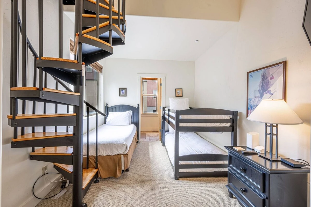 The guest room features 3 twin beds, en suite bathroom and a loft with spiral staircase! When the bedroom has a built-in loft, reading time just got a