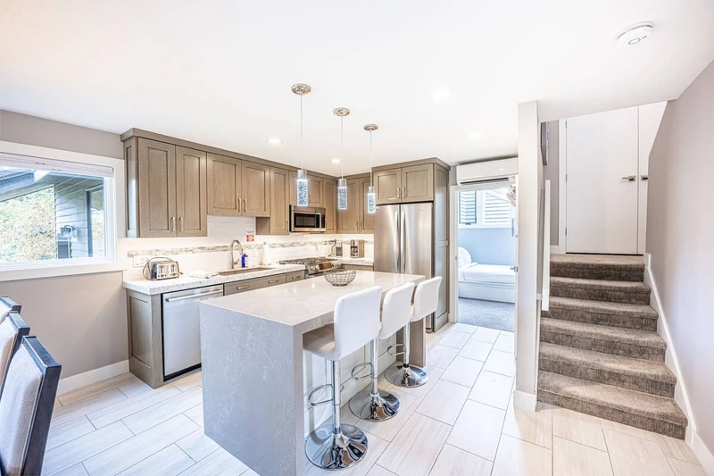 The Fully Stocked, Gourmet Kitchen Features High End Bosch Appliances, Breakfast Bar w Waterfall Edge, Under Cabinet Lighting, Keurig Coffee Maker, Ga
