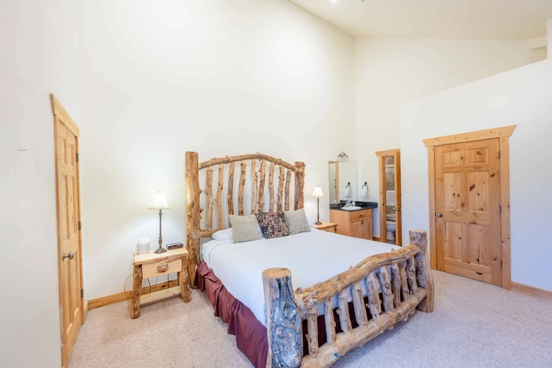 The primary suite features a custom king bed with high quality linens and bedding, beautiful log pole bed frame and flat-screen TV with Comcast TV.