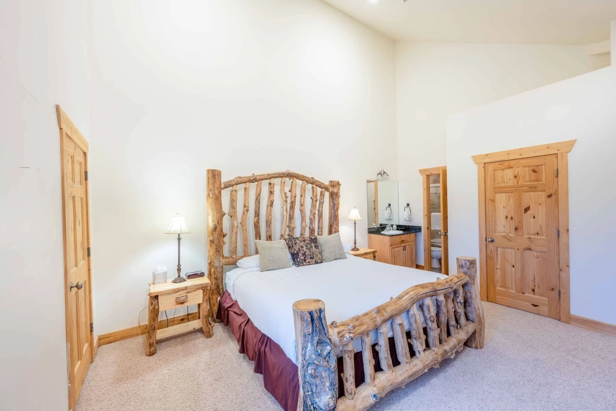 The primary suite features a custom king bed with high quality linens and bedding, beautiful log pole bed frame and flat-screen TV with Comcast TV.