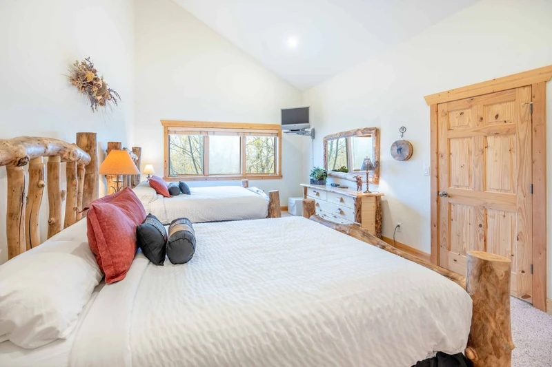 Each suite has it's own private bathroom. This is the warm and inviting guest suite which is filled with natural light, the vaulted ceilings help to r