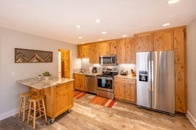 Newly Remodeled Red Pine Home - The Kitchen Features Subway Tiles, Full Size Stainless Steel Appliances, Breakfast Bar for 2, Granite Countertops