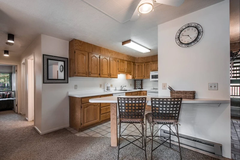 The kitchen has been updated with new counters, breakfast bar with seating for two (2) and complete with appliances.