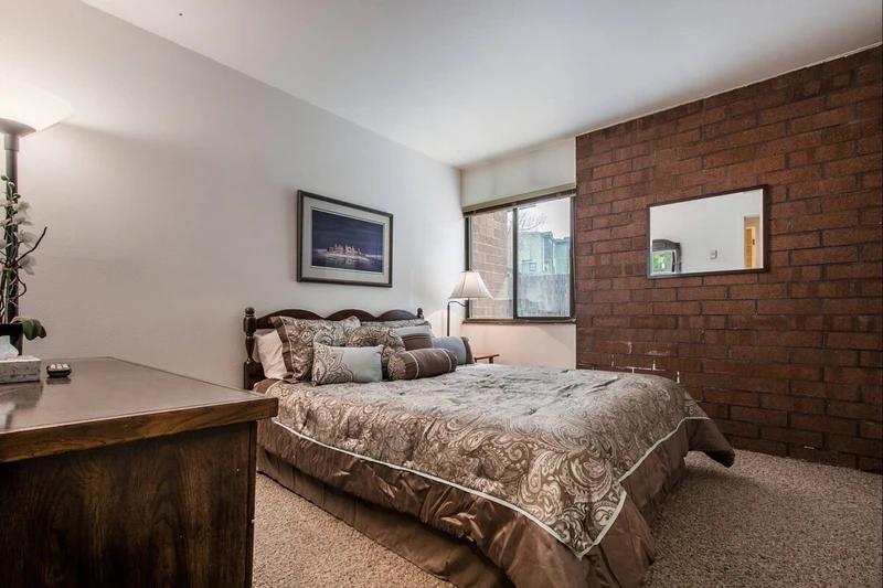 The second bedroom features a queen-size bed with comfortable linens and bedding, closet and large dresser.