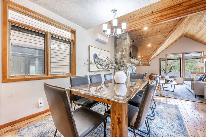 Experience the perfect family meal in our warm and inviting dining room. Adorned with a stunning hardwood table, eight chairs, and a comfortable break