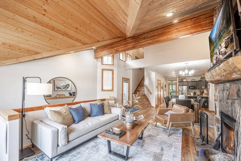 Alternate view of the main living space view showing layout, seating and fireplace