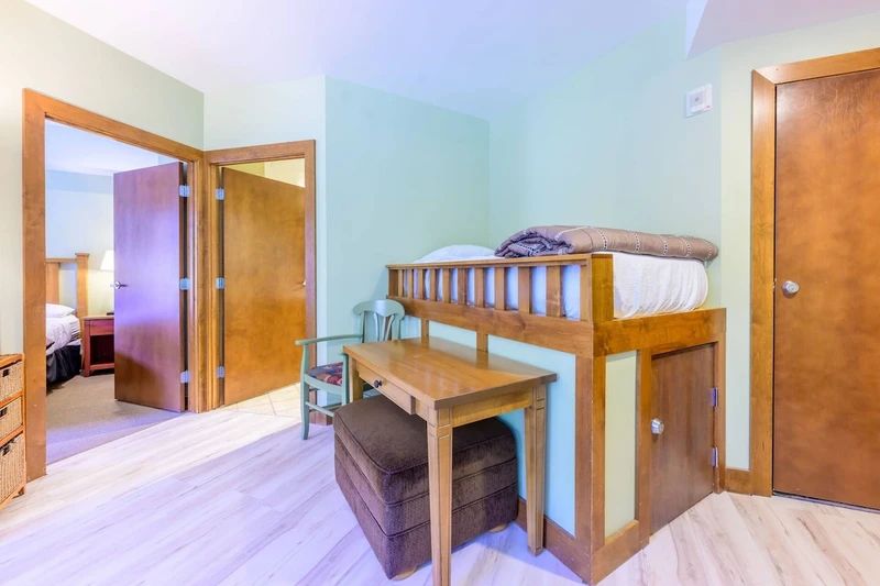 Built-in bunk nook with twin bed and desk - ideal for kids or extra sleeping space.