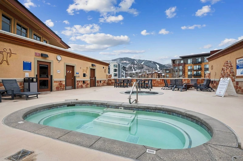 Community roof-top hot tub at Sundial Lodge with mountain views, perfect for unwinding after skiing at Park City Mountain.