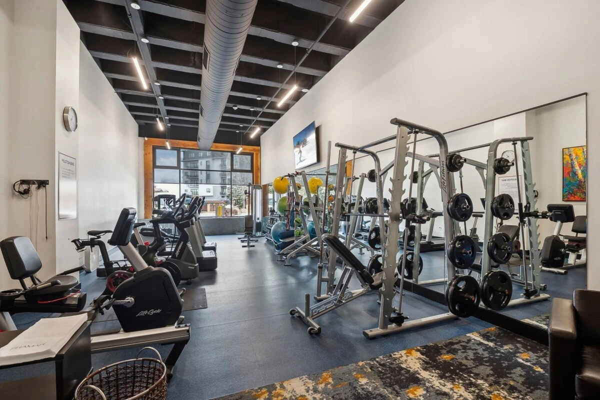 On-site fitness center at Sundial Lodge with cardio equipment and free weights for guests.