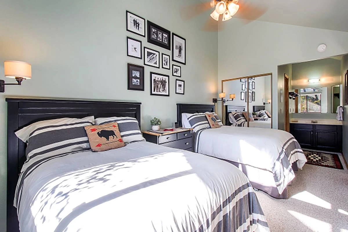 The first guest loft suite is bright & open with vaulted ceilings, two comfortable beds, remodeled bathroom with modern upgrades & decor throughout