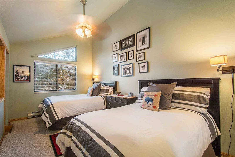The bedroom offers two (2) full size double beds with high-end bedding & linens, large dresser, cathedral ceilings & closet.