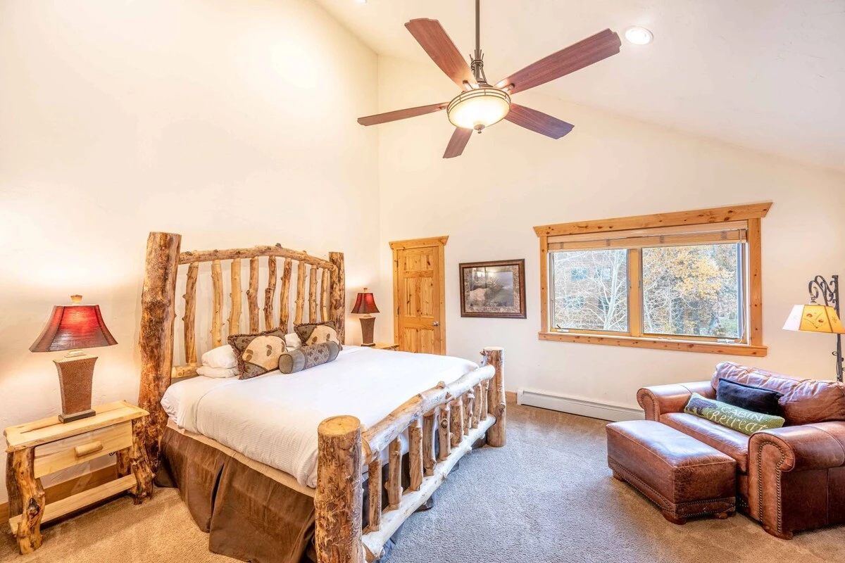 Modern Cabin Primary Suite Featuring a Custom King Size Bed, HDTV, Vaulted Ceilings, En Suite Bathroom, Reading Nook with Overstuffed Leather Ch