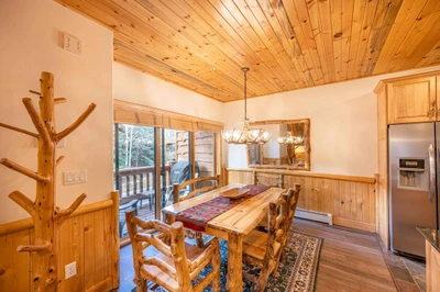 The warm and inviting dining room is a perfect place to enjoy a family meal - we have a gorgeous knotty pine hardwood table with 4 chairs and a comfor