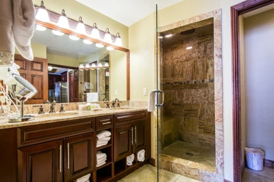 Master bathroom (1) with his and hers vanity, granite counters and a large steam/rainfall shower.